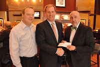 National valet company parks big donation check in hands of Simon Youth Foundation