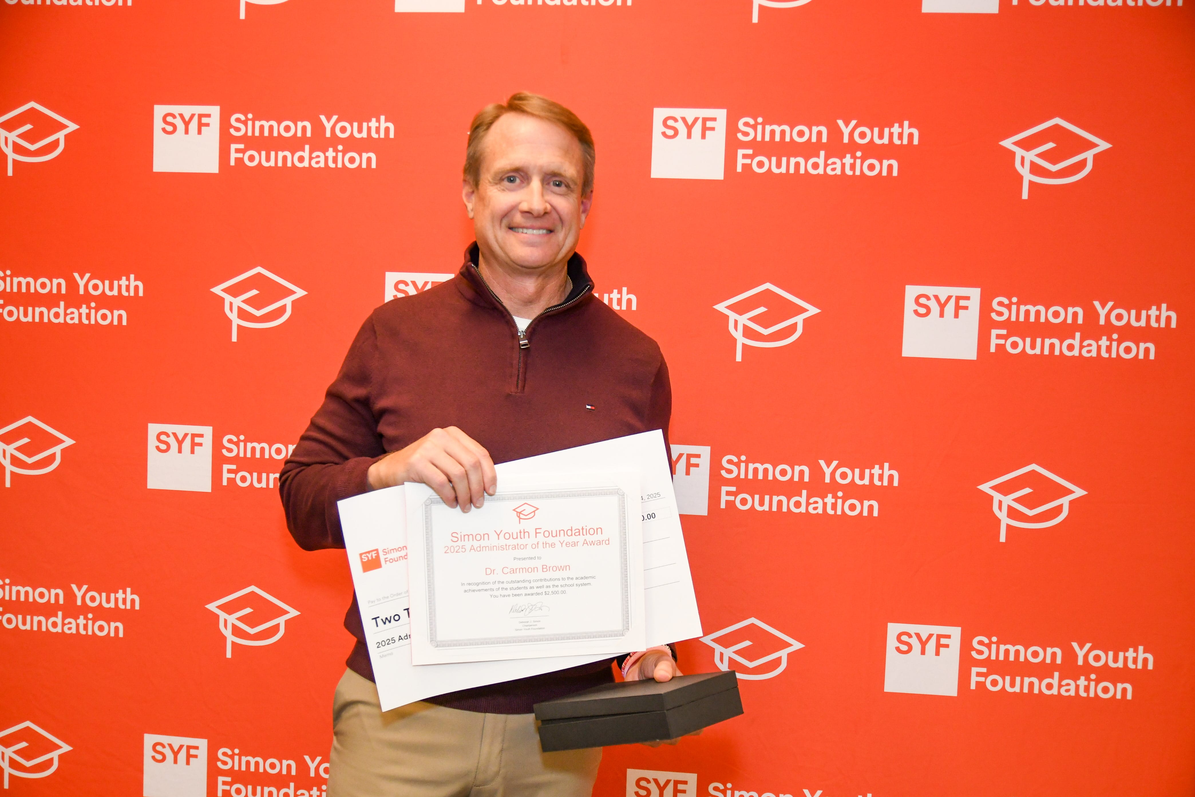SYF Awards Night 2025_0000080-min Carmon Brown, SYF Administrator of the Year, photographed with his award.